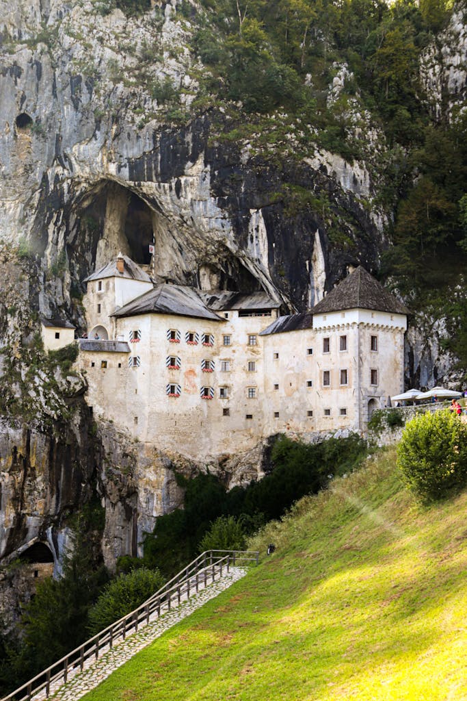 Explore a unique medieval castle nestled into a towering cliffside, merging nature and architecture.